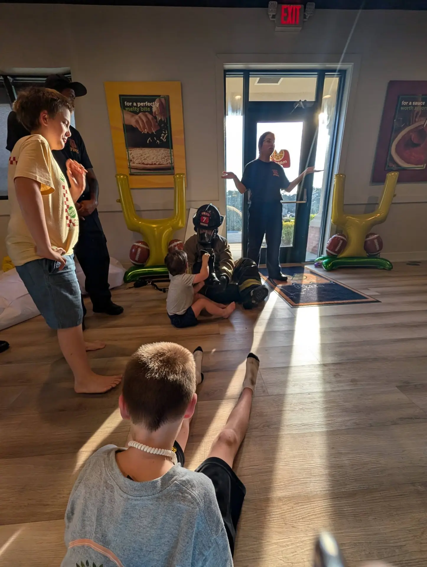A firefighter suited up so the kids could see a friendly face underneath the gear.